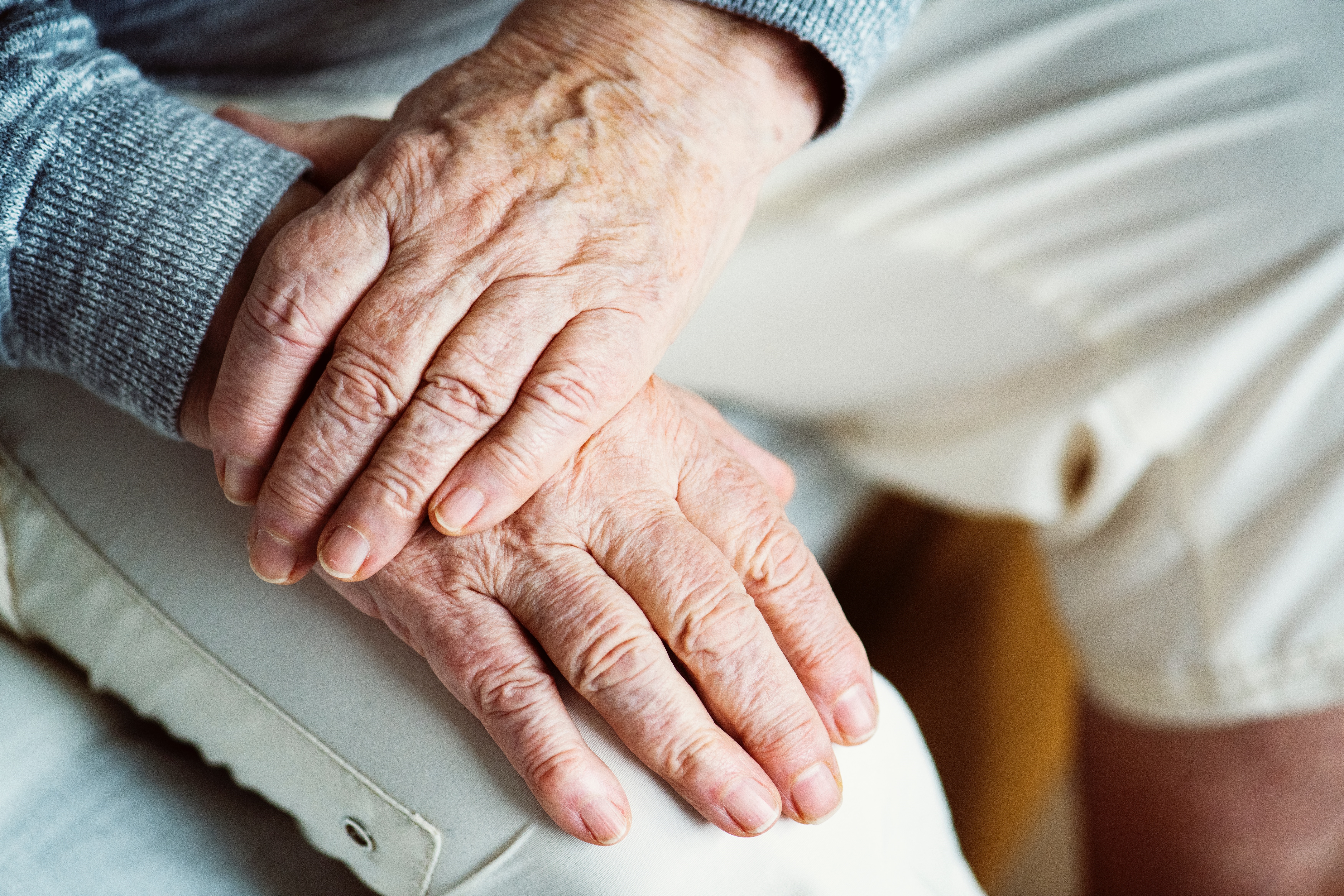 elderly person hands on lap rawpixel-769305-unsplash.jpg